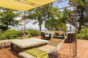 a patio with a tent and chairs and a table at Villa Scozilia in Piedimonte Etneo