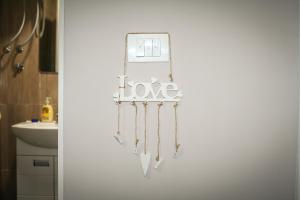 a wall with a sign that says love at Alex Lodge in Zrenjanin