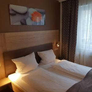 Postel nebo postele na pokoji v ubytování Hotel Wacker