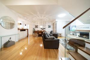 a living room with a couch and a dining room at Apartment Garden Terrace in Zadar