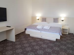 Postel nebo postele na pokoji v ubytování hotel Chmelnice
