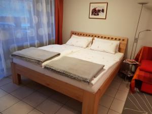 a bed with two pillows on it in a room at City Appartement 5 in Freiburg im Breisgau