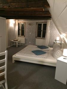 a bedroom with a large white bed in a room at Himmel & Hölle in Quedlinburg +34 photos