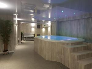 a bathroom with a large tub in a room at Gwesty'r Marine Hotel & Spa in Aberystwyth