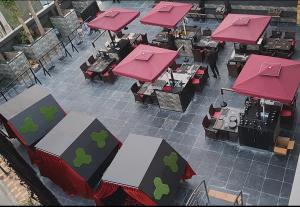 an overhead view of a restaurant with red roofs and tables at Hotel Stellar in Vadodara