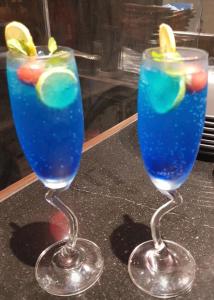 two cocktails in wine glasses sitting on a counter at Hotel Stellar in Vadodara