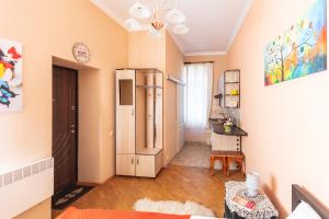 a living room with a refrigerator and a table at Smart Lwow House in Lviv
