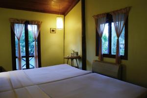 Postel nebo postele na pokoji v ubytování Sala Done Khone Hotel