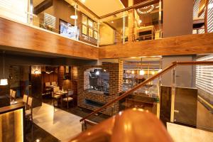 a lobby with a staircase and a dining room at Hotel Paramos Inn in Bangalore