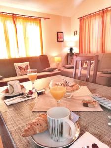 a living room with a table with food and drinks at Apartment Marina in Slatine