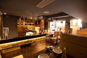 a restaurant with a bar and a dining room at Hotel Paramos Inn in Bangalore