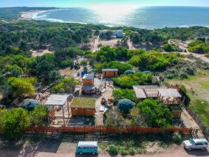 an aerial view of a house next to the ocean at Complejo Playa Grande in Punta Del Diablo