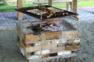 a brick fire pit with food cooking in it at Pod Orzechem in Sanok