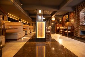 a restaurant with a lobby with a bar at Hotel Paramos Inn in Bangalore