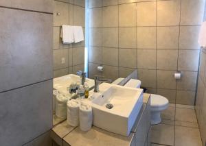 a bathroom with a sink and a toilet at Hotel Maya Rue in Palenque