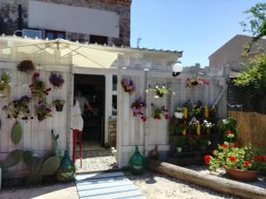 a person standing in a garden with flowers in a fence at Room73 in Paestum