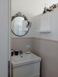 a bathroom with a sink and a mirror on the wall at B&B Rosalu - Adults Only in Sirmione