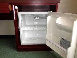 an empty refrigerator with its door open in a room at Hotel Union in Kagoshima