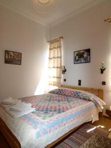 a bedroom with a bed with a quilt on it at Villas Michalis in Chorafakia