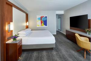 a hotel room with a bed and a flat screen tv at Hyatt Regency Atlanta in Atlanta