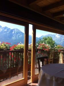 a view of mountains from a balcony with a table at Les Combes in La Salle