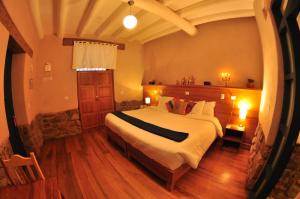 a bedroom with a bed and a dresser at Nao Victoria Hostel in Cusco