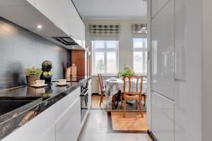 a kitchen with a table and a dining room at Lion Apartments - Parkowa 41m4 plaża 2 min in Sopot