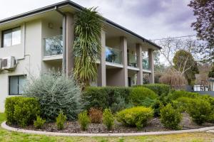 a house with plants in front of it at Apex Park Holiday Apartments in Wangaratta