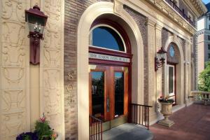 una entrada a un edificio con puerta de madera en The Inn at the Union Club of British Columbia, en Victoria