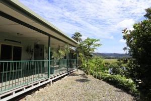 a porch of a house with a view of a field at Daintree Riverview Lodges in Daintree