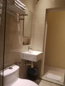 a bathroom with a sink and a toilet and a shower at The V Hotel in Kuantan