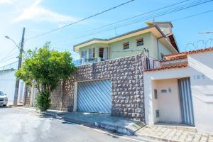a house with a garage on a street at POUSADA DONA DORA 2 in Piumhi