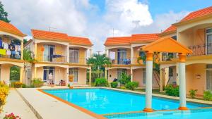 a villa with a swimming pool in front of houses at Residence Le Choisy in Mont Choisy