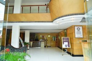 a lobby of a building with a staircase in it at Maurya Rajadhani in Trivandrum