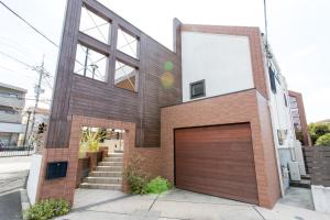 a brick house with a garage at Danro no Yado Concept House Hoshida in Katano