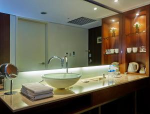 a bathroom with a bowl sink on a counter at Hotel Kukdo in Seoul