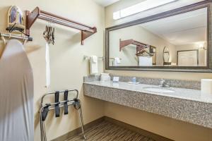 a bathroom with a sink and a mirror at SureStay Hotel by Best Western Tupelo North in Tupelo +15 photos