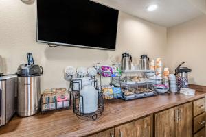 a kitchen counter with a tv on a wall at SureStay Hotel by Best Western Tupelo North in Tupelo