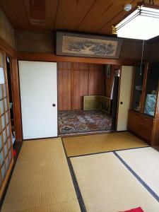 an empty room with two doors and a rug at Ikkenya Kitagata in Okayama