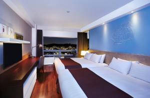 Ένα ή περισσότερα κρεβάτια σε δωμάτιο στο Hotel Kukdo