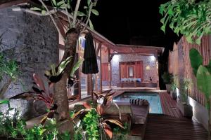 a house with a swimming pool in a yard at Samsara Villas in Gili Islands