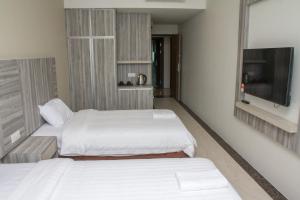 Postel nebo postele na pokoji v ubytování Grand Wonderful Hotel