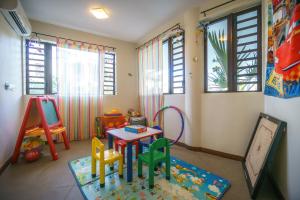 a childs room with a table and chairs in it at Villasun Luxury Apartments & Villas in Flic-en-Flac