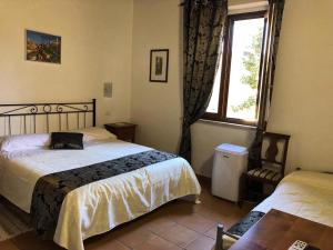 Łóżko lub łóżka w pokoju w obiekcie Villa Tuscany Siena