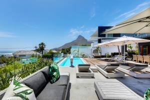 a villa with a swimming pool and a house at Jo Leo House by Totalstay in Cape Town