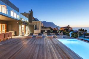 a villa with a swimming pool and a deck at Jo Leo House by Totalstay in Cape Town