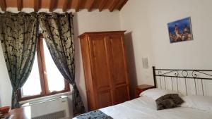 Łóżko lub łóżka w pokoju w obiekcie Villa Tuscany Siena