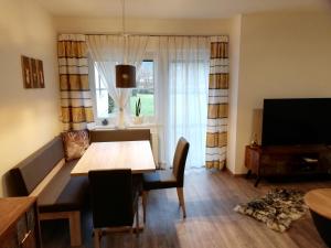 a dining room with a table and a window at Schmaranzer in Bad Ischl
