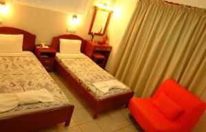 Postel nebo postele na pokoji v ubytování Hotel Afroditi