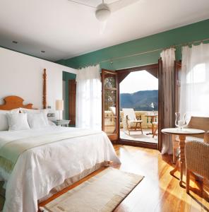 a bedroom with a bed and a view of a patio at La Casona del Viajante - Adults Only in Villabajo